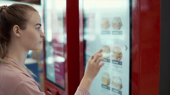 Woman Choosing Fast Food in Digital Menu