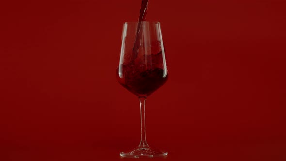 Slow Motion of Pouring Red Wine in Glass at 1000 Fps Red Background