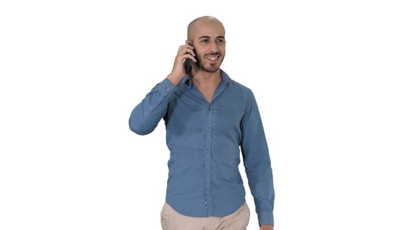 Young arab man walking and talking on the phone and smile