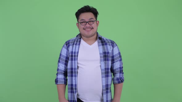 Happy Young Overweight Asian Hipster Man Smiling
