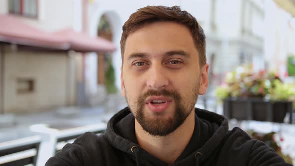 Close Up Male Sit Talking Outside Cafe