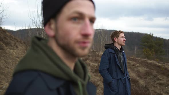 Two Friends Are Standing On Hill In Nature. Around The Tree And Dry Grass.