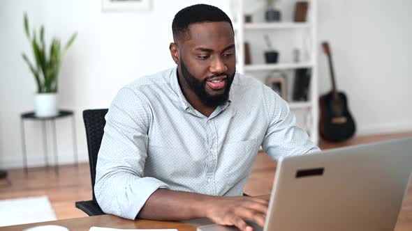 An African Guy Is Using Laptop for Work