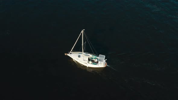Aerial View of Yacht with Solar Panels Sailing Sea or River on Sunrise