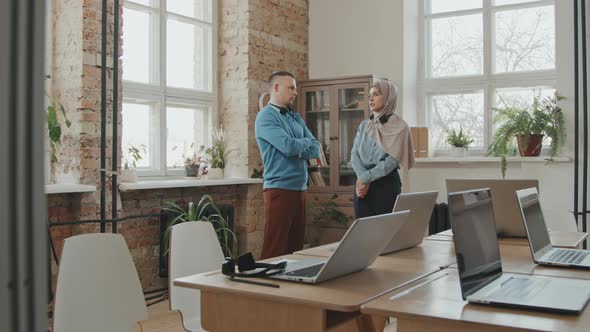 Call Center Workers Chatting in Office