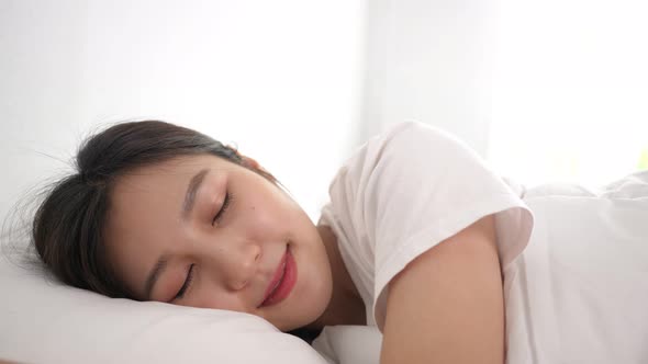 Young beautiful woman sleeping on bed with feeling sweet dream