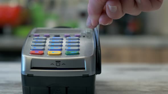 Woman Swiping Her Credit Card on a Terminal To Finalize Her Purchase