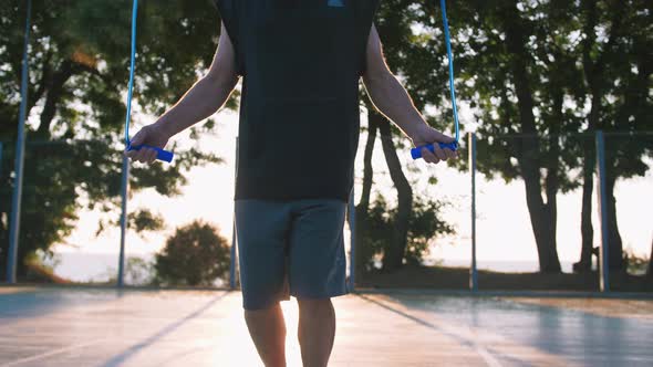 Handsome Middle Aged Man with Long Gray Beard Jumping a Rope During Sunsise Close Up Shot Slow