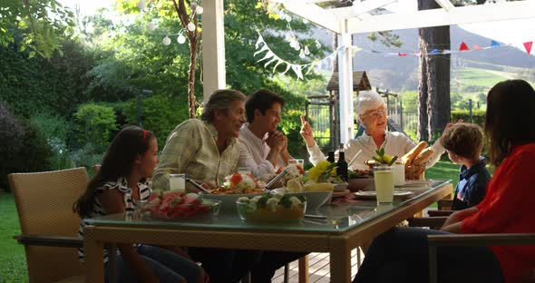 Family eating outside together in summer