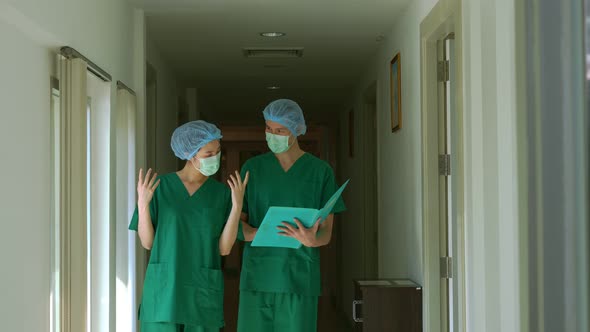 Two surgeon doctors discussion in front of the operating room for a new emergency case. Two Health C