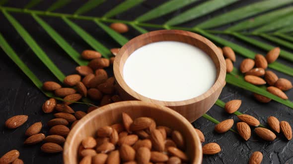 Close Up of Almonds in Wooden Bowl and Almond Milk