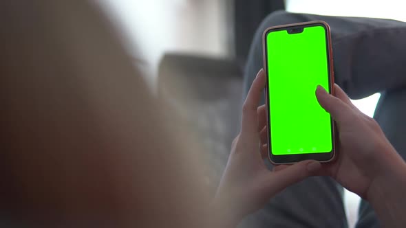 Phone with Green Screen and Chroma Key in Hands closeup. Chromakey Mockup.