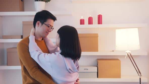 Young Asian Couple Dancing and Hugging in New Apartment