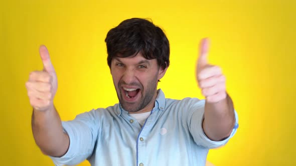 Handsome Smiling Guy Isolated on Yellow Background in Studio