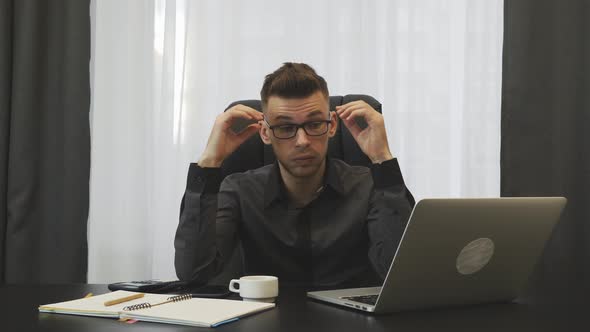 Businessman Tired After Overtime Work in Office on Computer