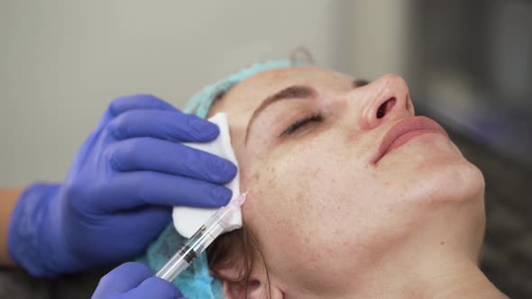 Woman on the Procedure of Mesotherapy Injection with a Syringe