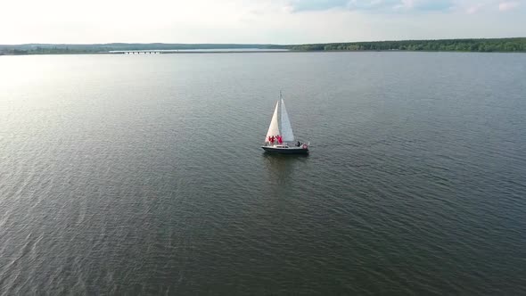 Women in Red Clothing Traveling on Sailing Boat