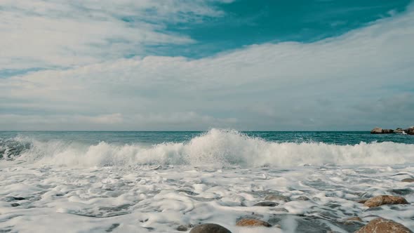 Sea Waves Are Crashing on Stones and Spraying in Slow Motion, Beautiful Beach in Crimea with Stones