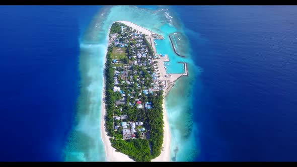 Aerial drone shot abstract of tropical tourist beach vacation by aqua blue water with clean sandy ba