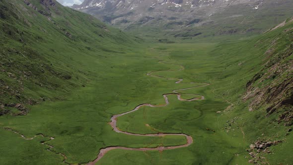 Curved river in mountainous valley