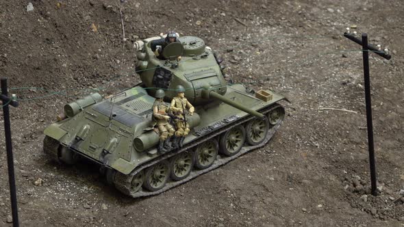 An Exhibition of Army Car Models. A Close Up View of a Tank with Soldiers on It.