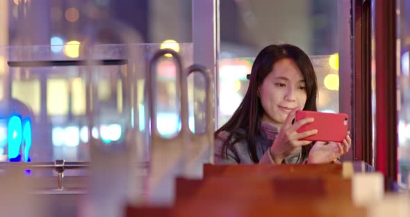 Woman take photo on tram