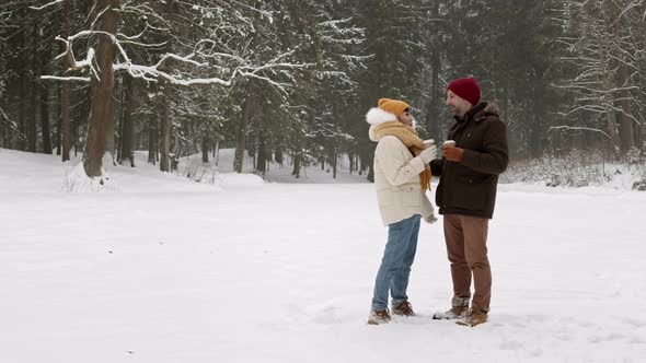 Happy Couple in Snowy Woods