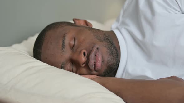 Young African Man Snoring in Bed Sleeping