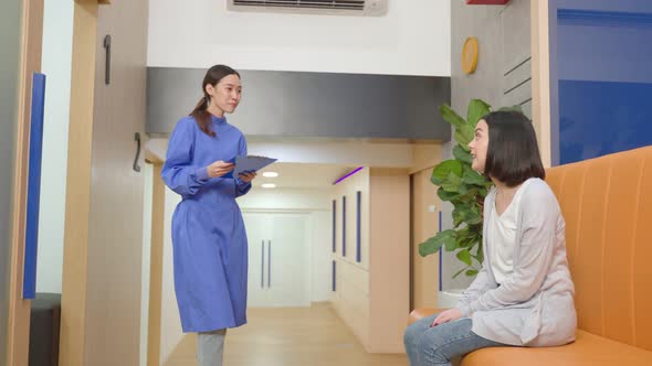 Asian young woman dental assistant bring caucasian beautiful girl patient at dental care clinic.