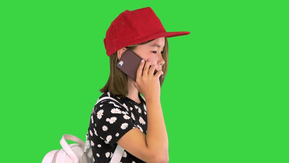 Young Asian Girl Talking on Smart Phone on a Green Screen Chroma Key