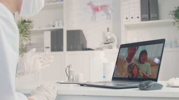 Asian veterinarian girl use laptop talk to pet owner on online virtual video call in pet hospital.