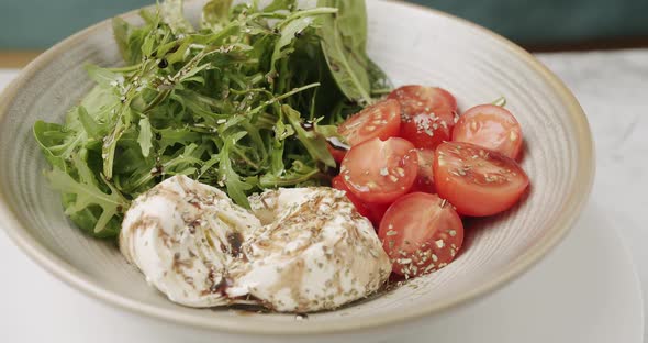 Tasty Salad in a White Plate on a White Background