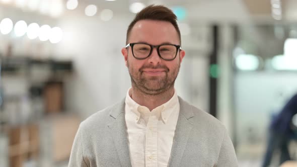 Cheerful Creative Man Waving at the Camera 