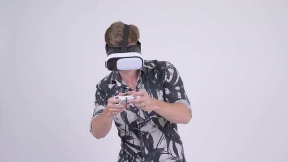 Young Tourist Man Playing Games and Using Virtual Reality Headset