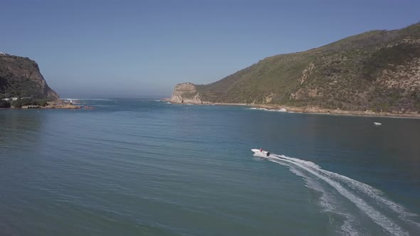 Tracking aerial as power boat motors to Knysna Heads in South Africa