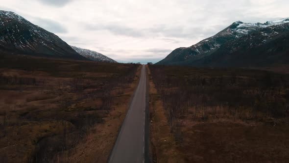 Road along hostile landscape on Kvaloya, Northern Norway, drone view