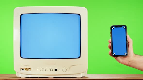 Old Television with Interference Screen on Green Background and Smartphone with Blue Chroma Key