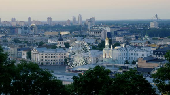 Evening Timelapse of Rotating Ferris Wheel in Kiev. Contract Square in Podil District with