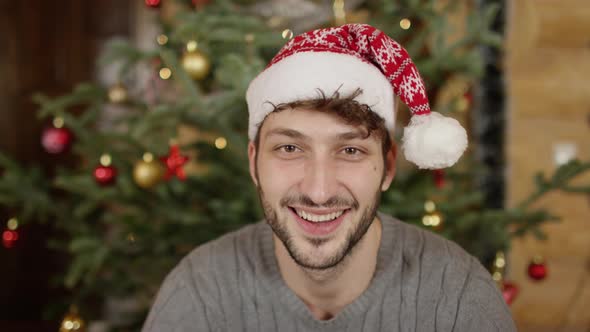 Man with Christmas hat smiling