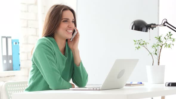 Creative Woman Talking on Phone at Work, Sharing Information