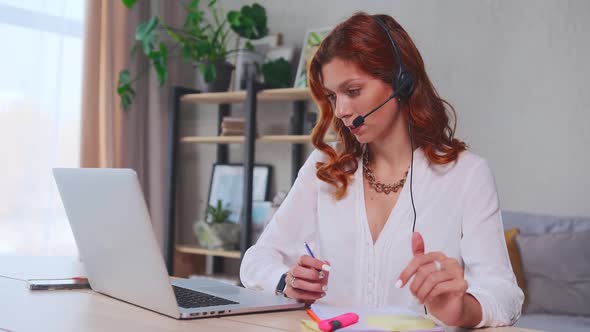 Focused Young Woman Freelancer Conducts Online Negotiations Through Laptop