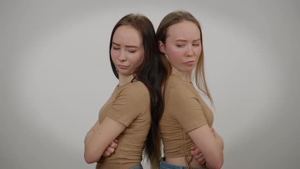 Side View Slim Young Beautiful Women Standing Back to Back at Grey Background