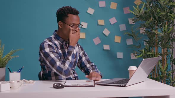 Shocked Man Doing Three Wise Monkeys Gesture at Desk