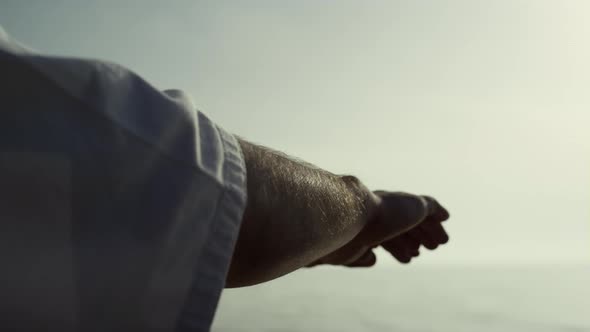 Sportsman Hands Waving Training Judo on Seacoast Close Up