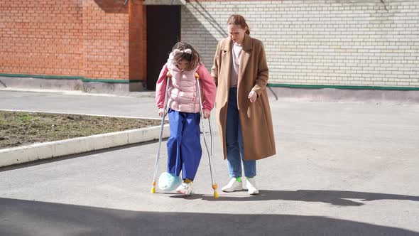 Mom Helps Daughter Learn to Walk on Crutches