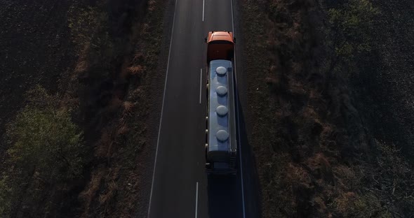 Food Industry Drone Flying Over Truck for Production of Milk is Leaving the Farm and Driving Along