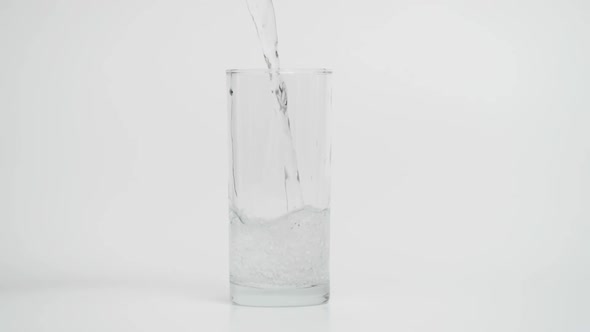 Slow Motion of Pouring Sparkling Water in Glass 1000 Fps in White Background