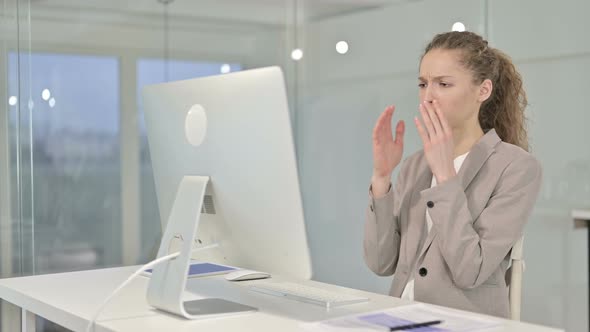 Hardworking Young Businesswoman Reacting To Failure on Desk Top 