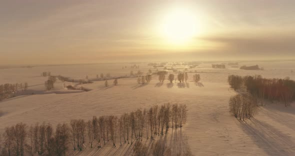 Aerial View of Cold Winter Landscape Arctic Field Trees Covered with Frost Snow Ice River and Sun