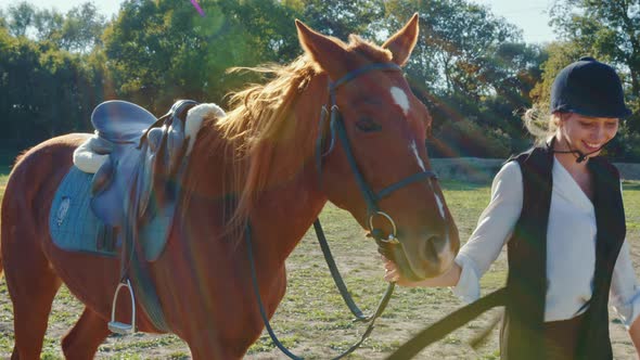 Equestrienne Walks with Harnessed Sorrel Horse
